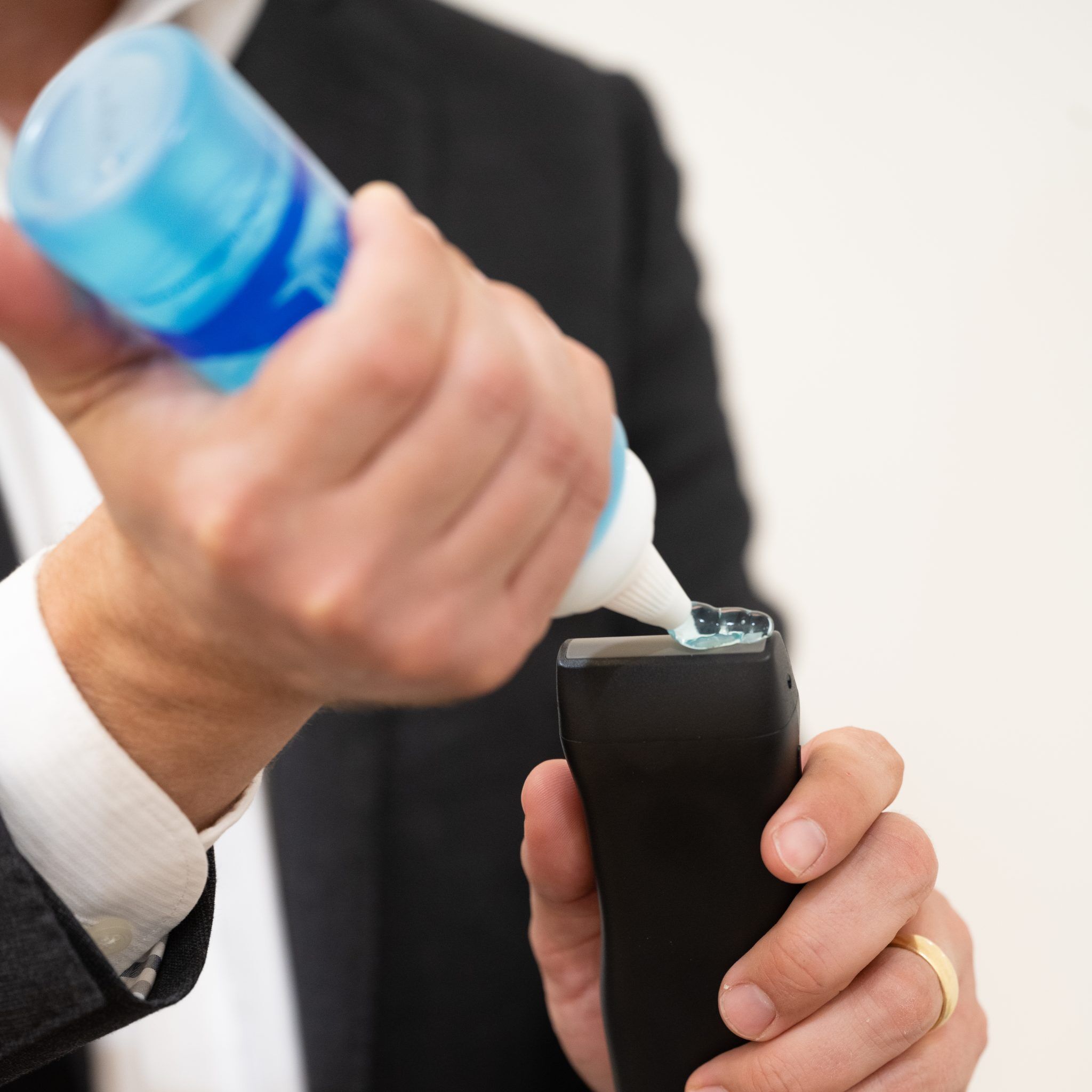 Healthcare professional applying ultrasound gel to device